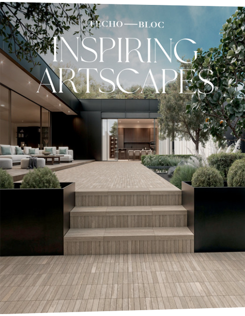 Beige tile walkway and steps lead to a dark building, with seating area and garden in the background.