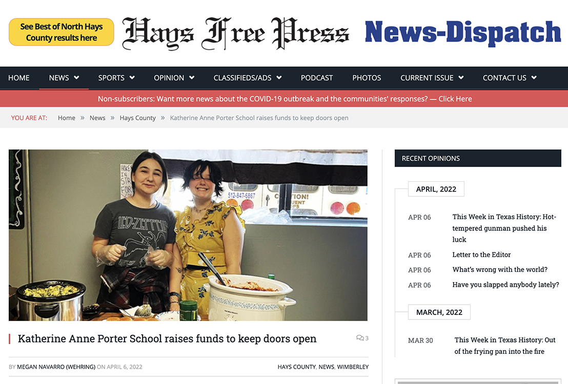 A couple of women are standing next to each other in a kitchen.