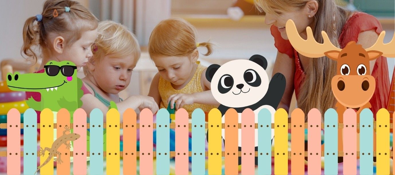 Children playing near a fence with cartoon animals.