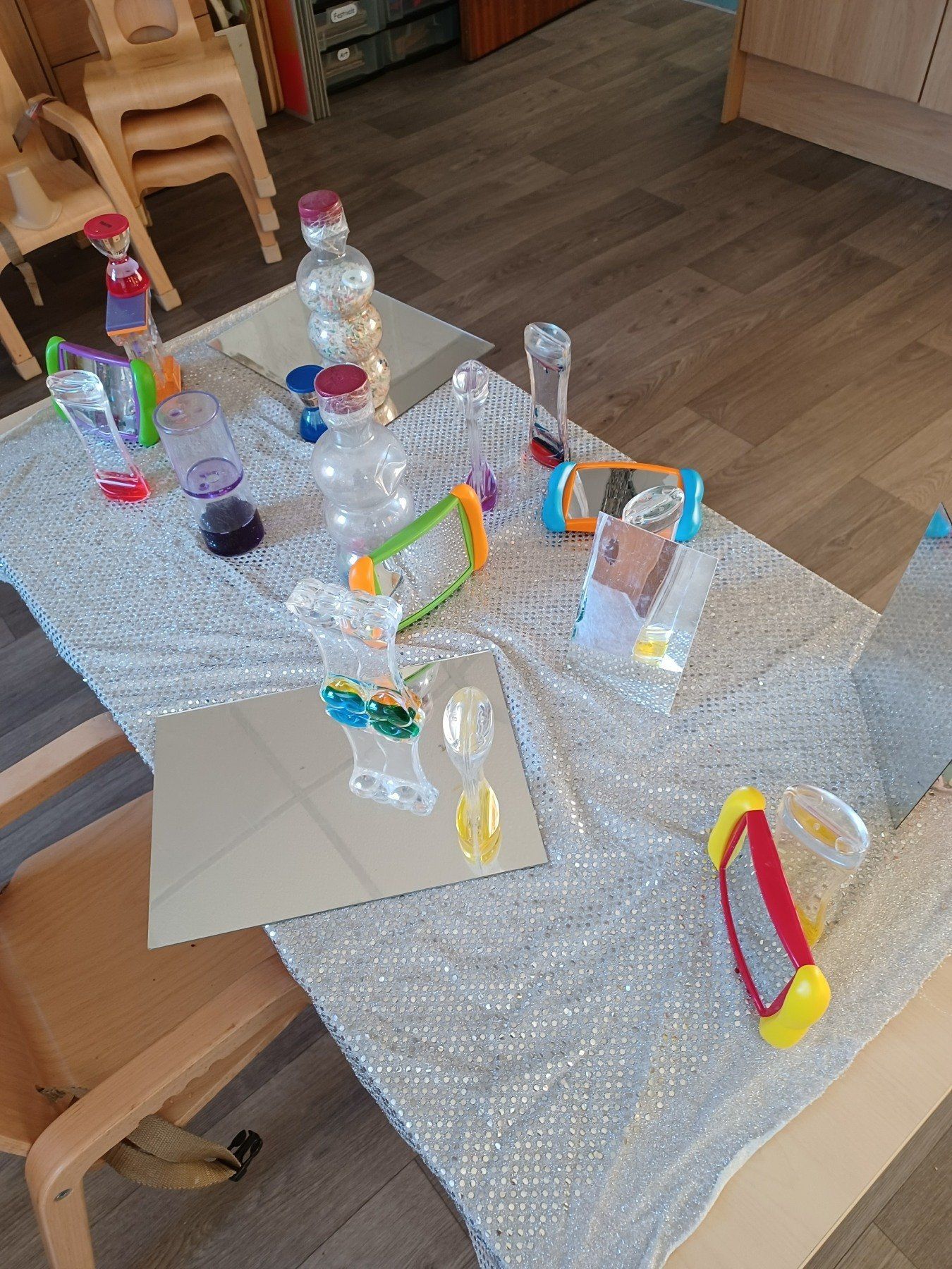 A table with a lot of toys on it and a mirror on it.