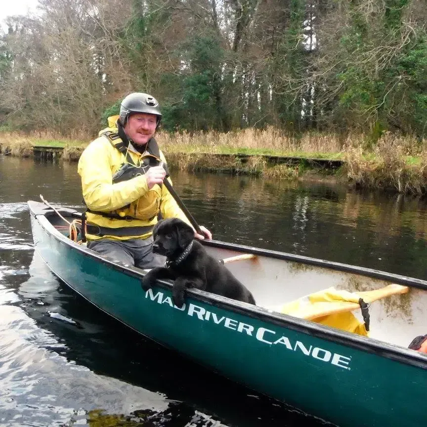 Paddle Northern Ireland | A man and a dog in a maj river canoe