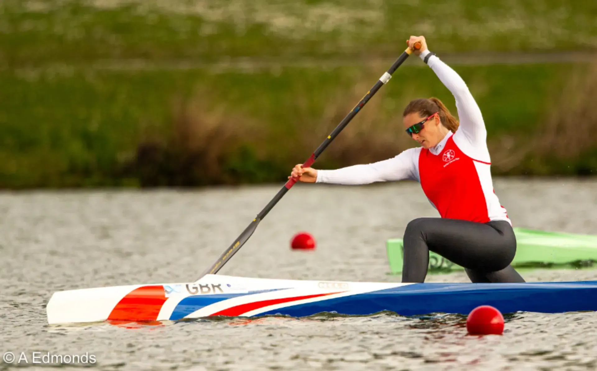 A man is paddling a red sako kayak