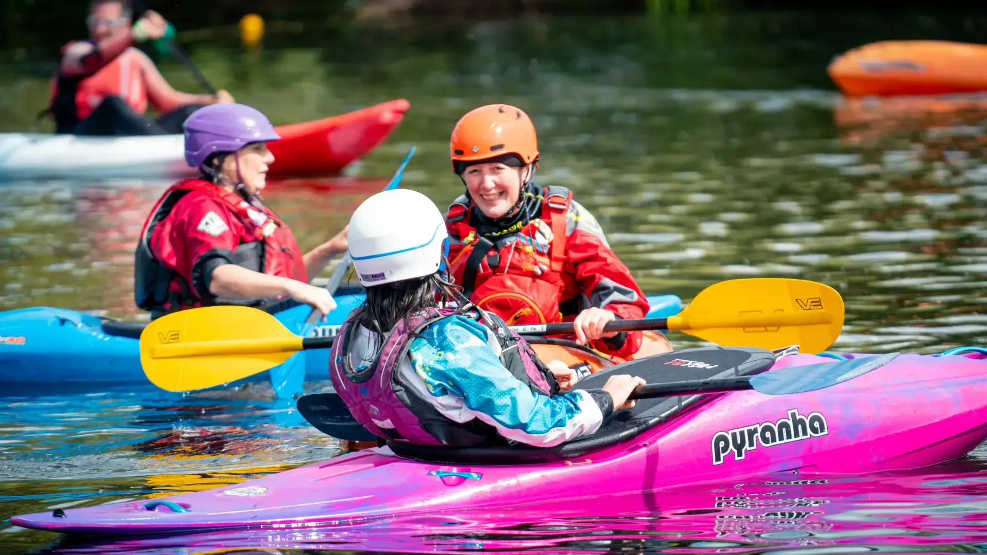 A man is riding a kayak down a river.