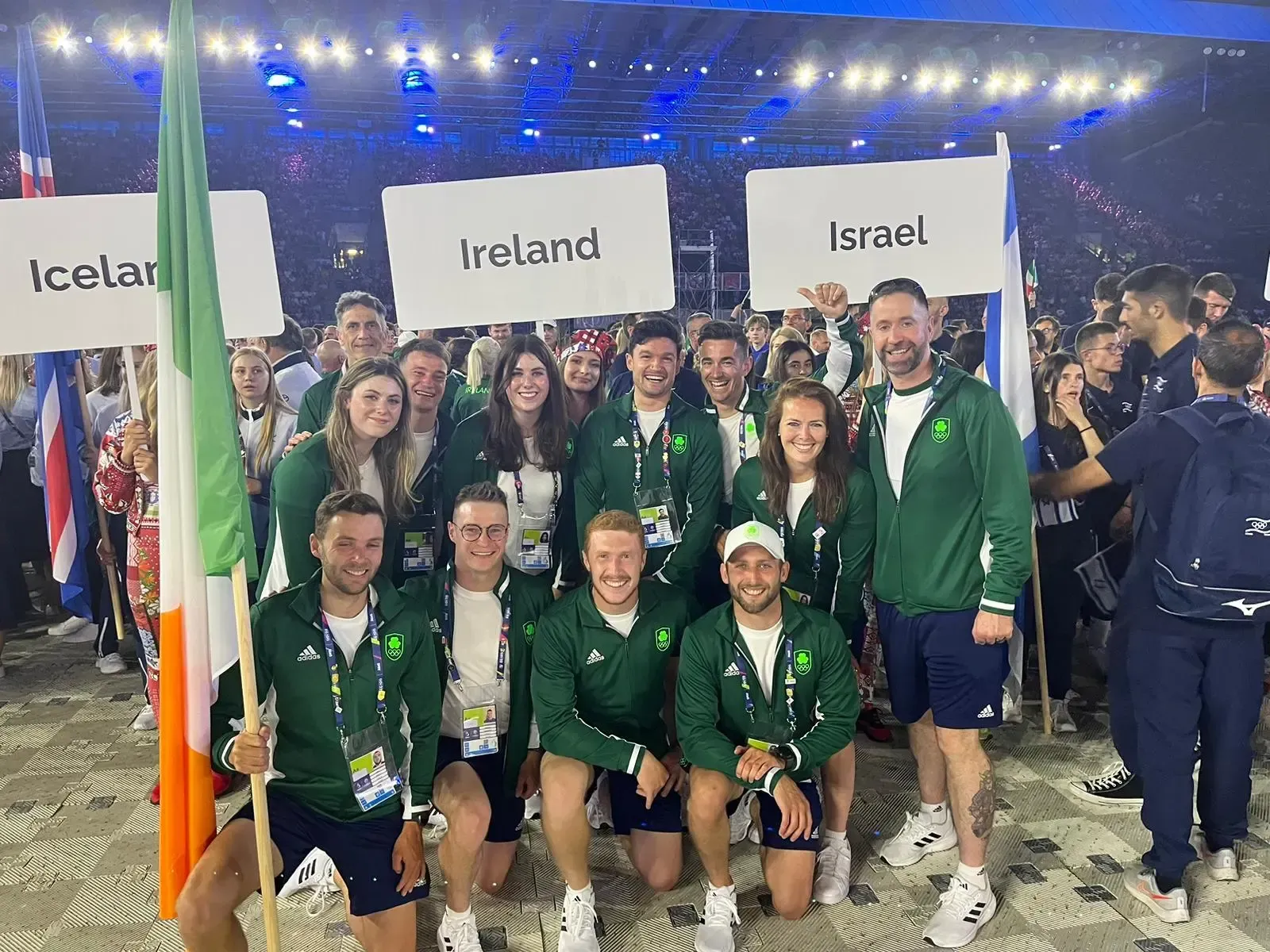 Paddle Northern Ireland | A group of people are posing for a picture while holding flags.