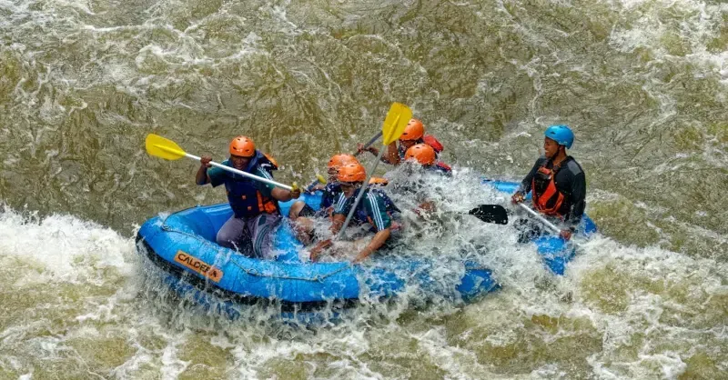 Paddler Northern Ireland | A group of people are rafting down a river.