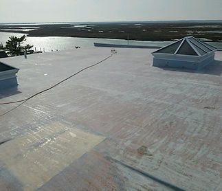 The roof of a building with a view of a body of water