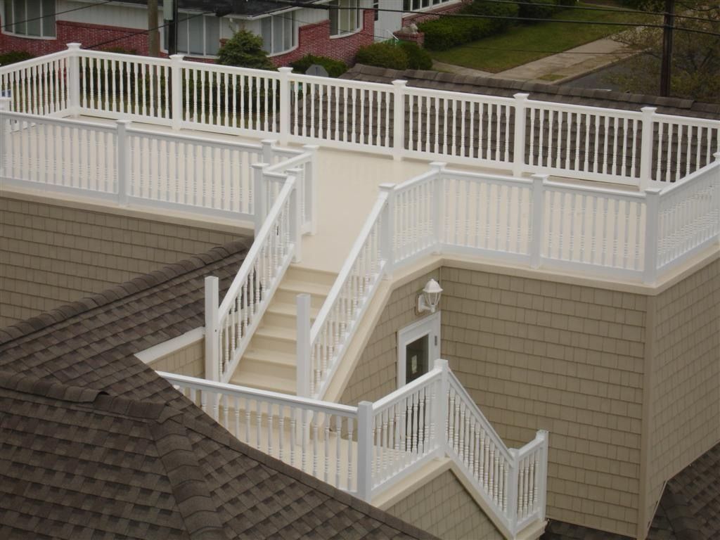 An aerial view of a house with stairs and a white railing