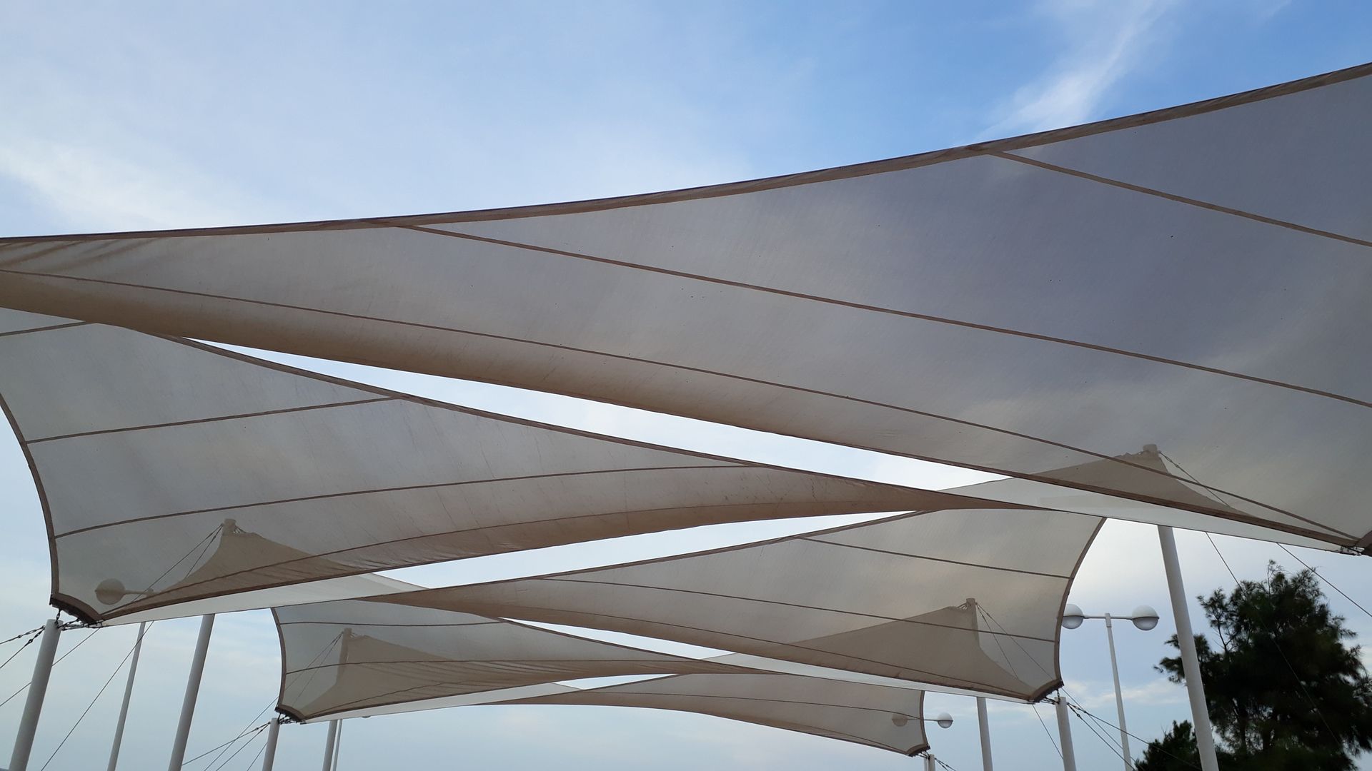 A row of white shade sail against a blue sky | Cordova & Pasadena, MD | Shoreline Awning & Trim