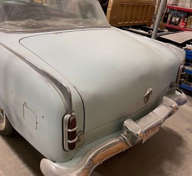 A light blue car with a license plate that says ' ec ' on it