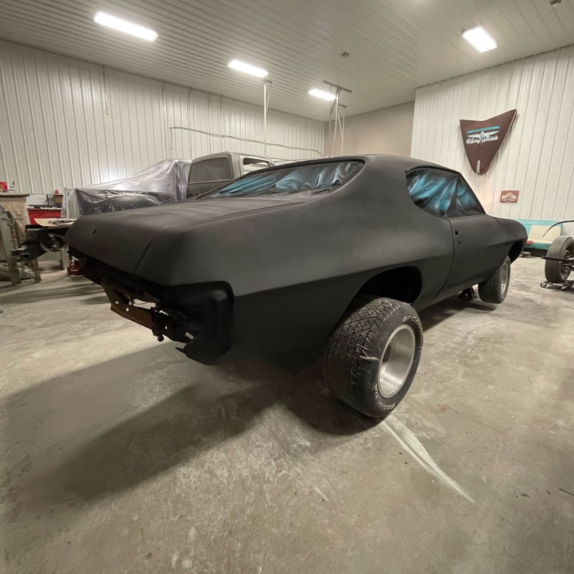 A black car is parked in a garage.