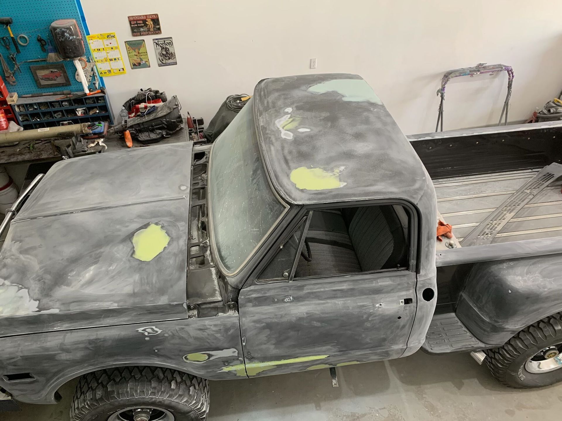 A gray truck is sitting in a garage.