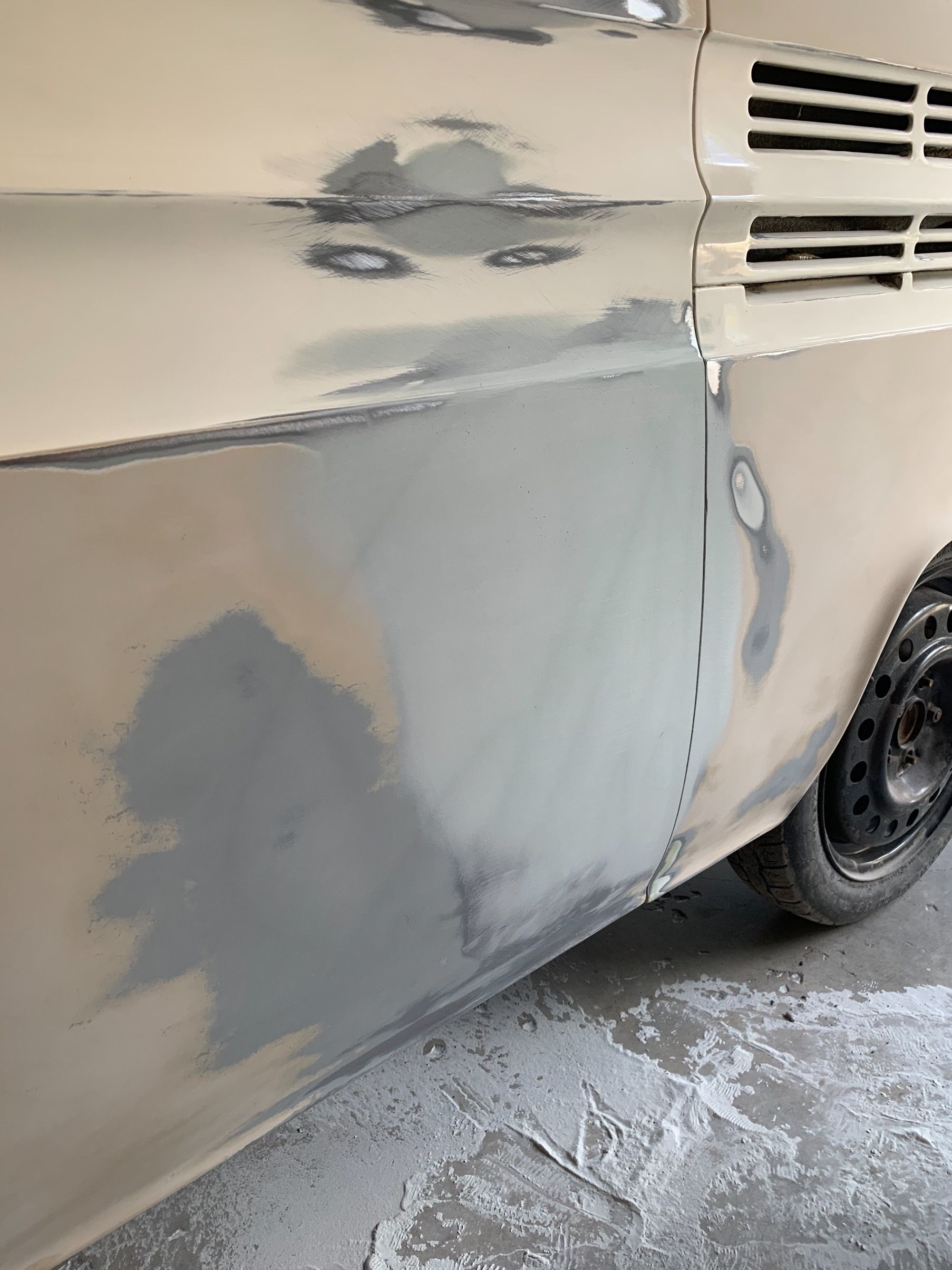 The side of a car is being painted.