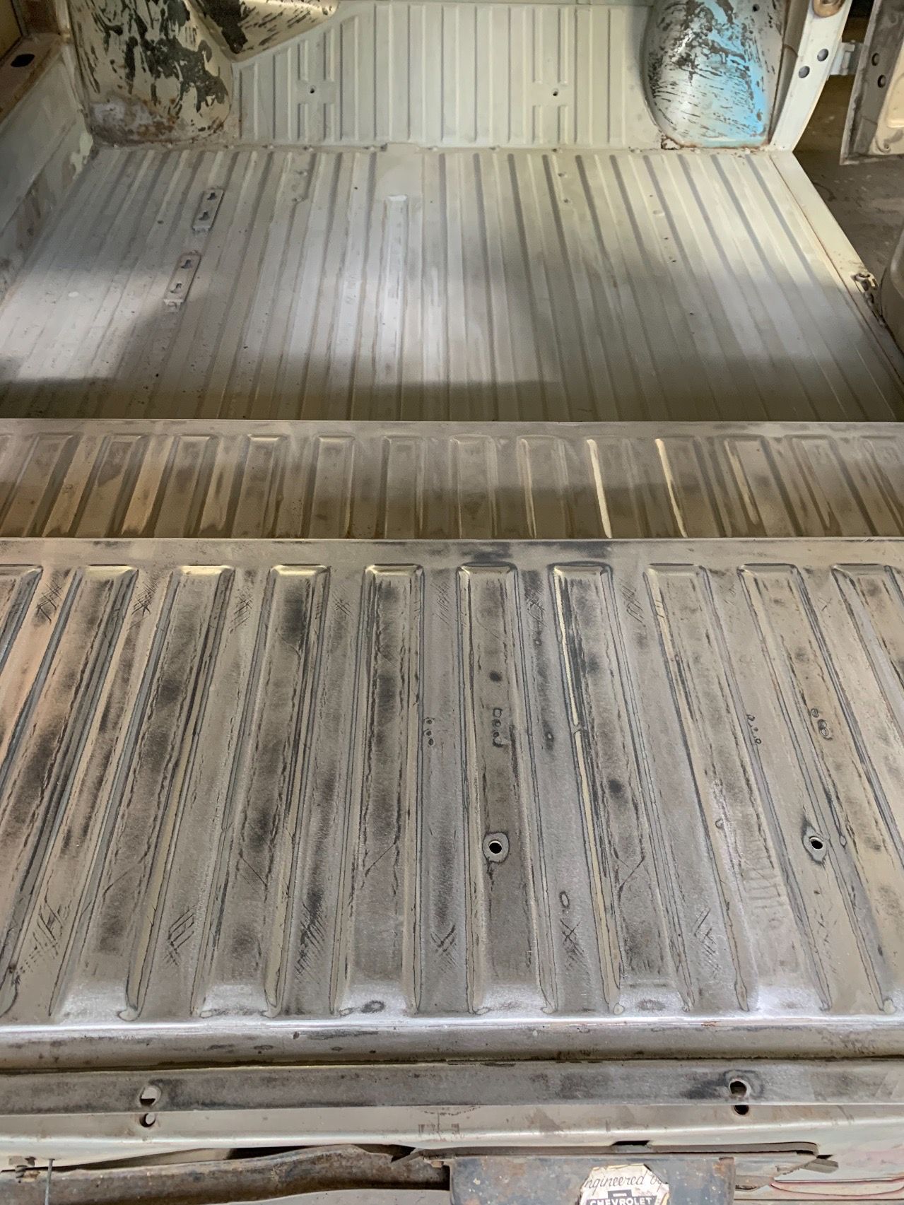 A close up of the back of a truck with a wooden floor.
