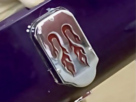 A close up of a purple car with flames on it