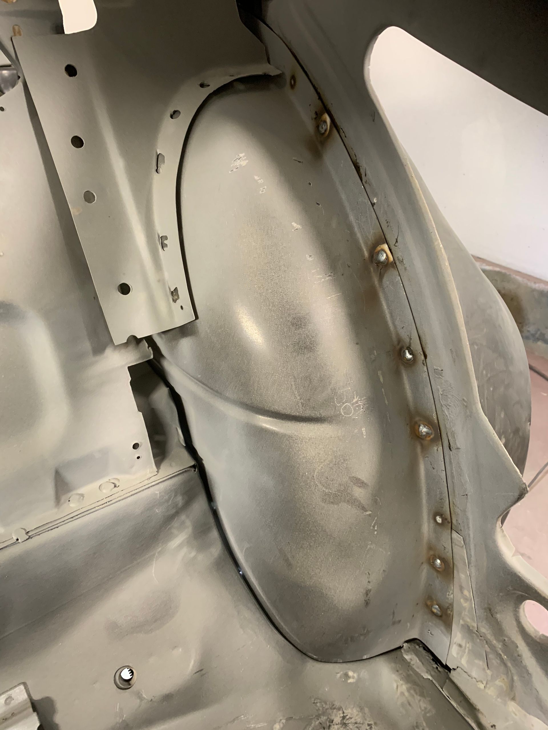 A close up of the inside of a car with a fender.