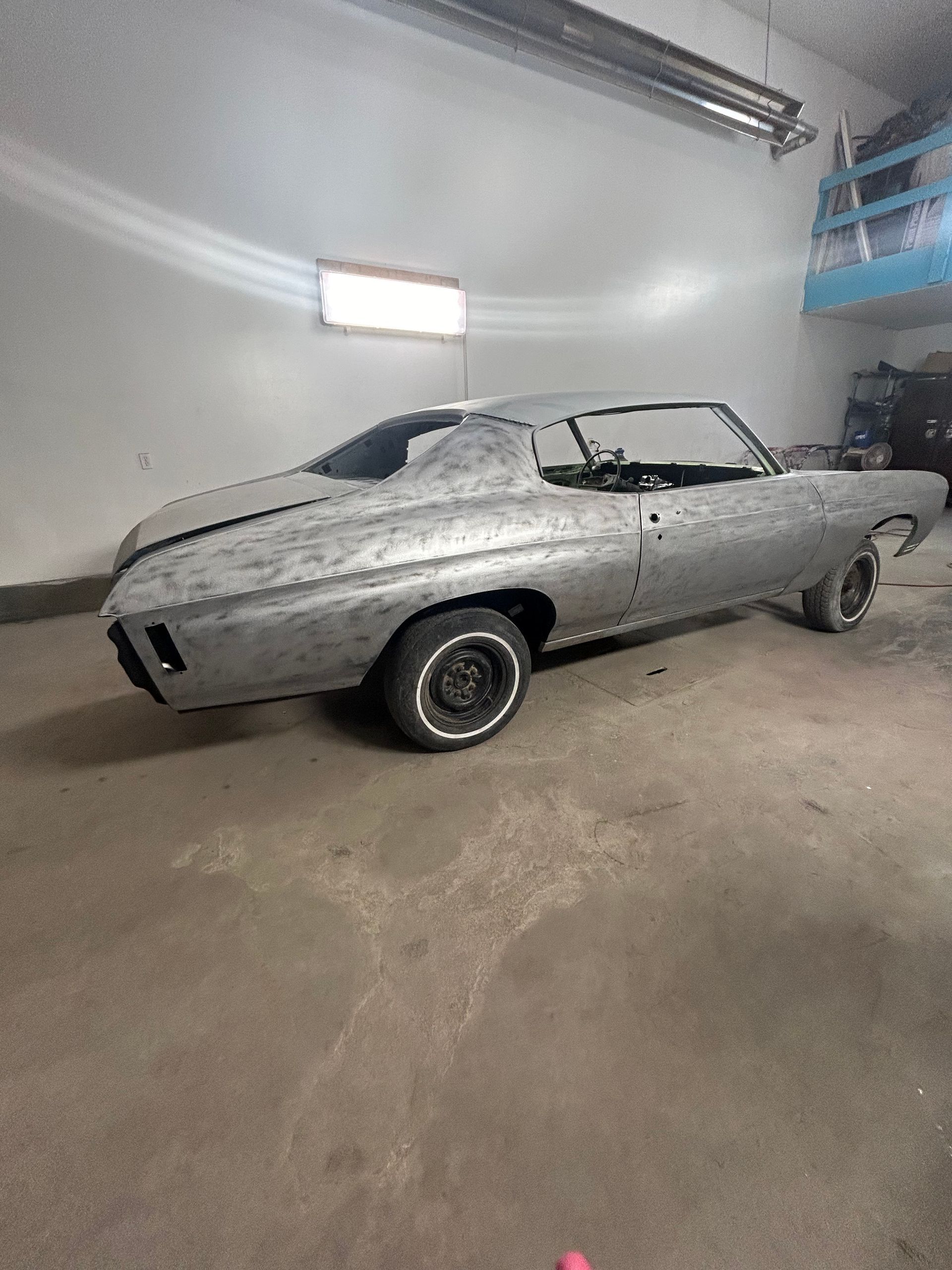 A silver car is parked in a garage.