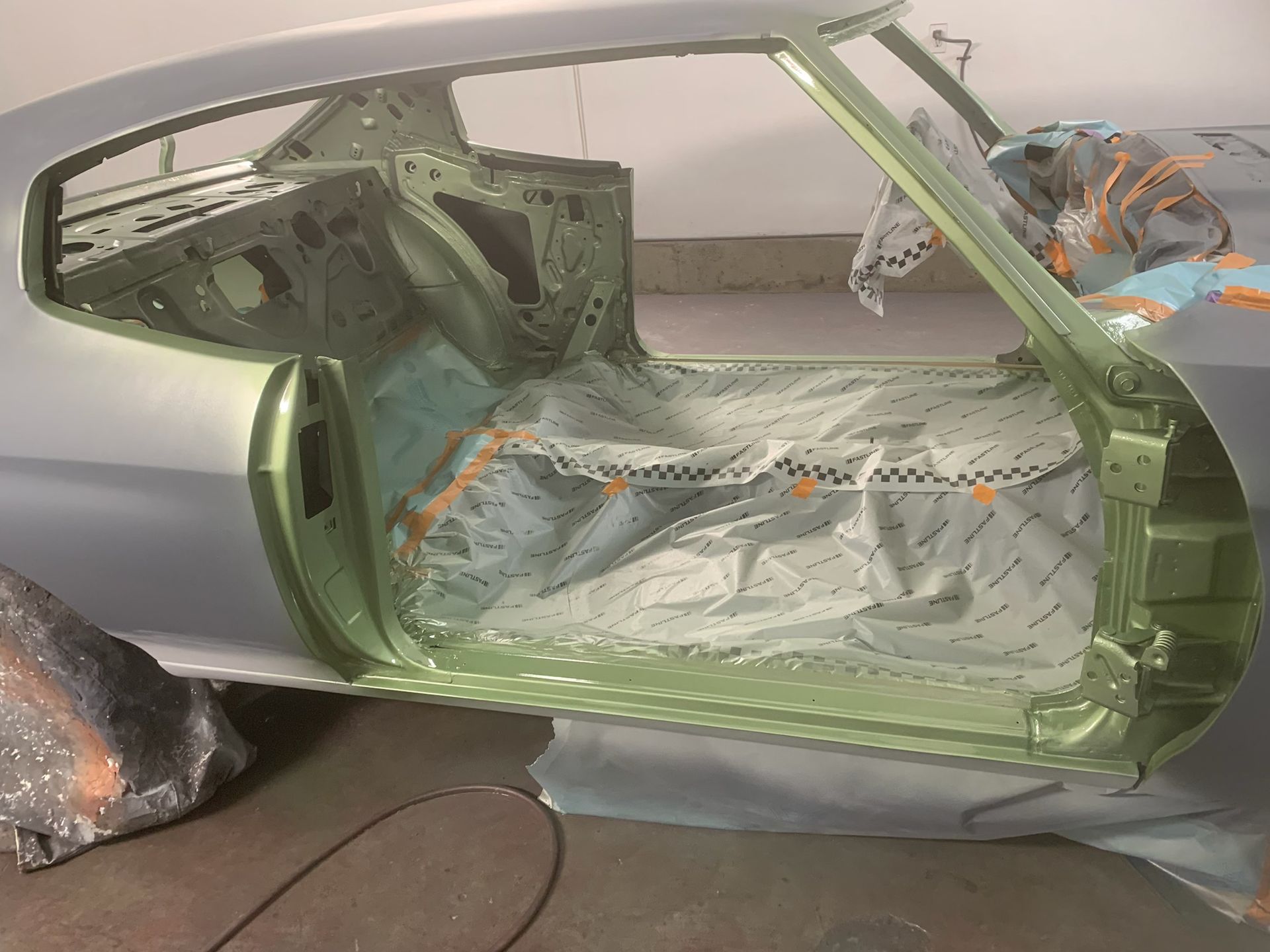 The inside of a car is being painted green