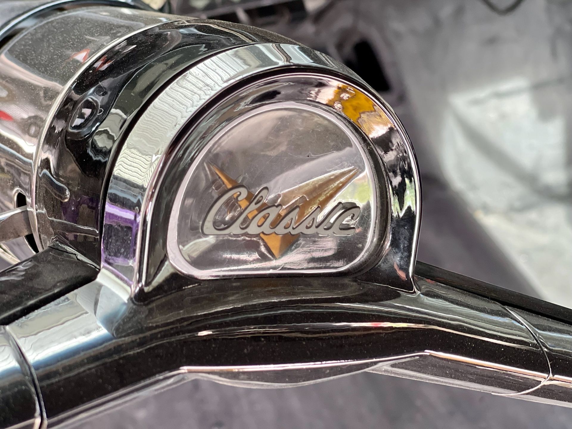A close up of a motorcycle handlebar with the word cadillac on it