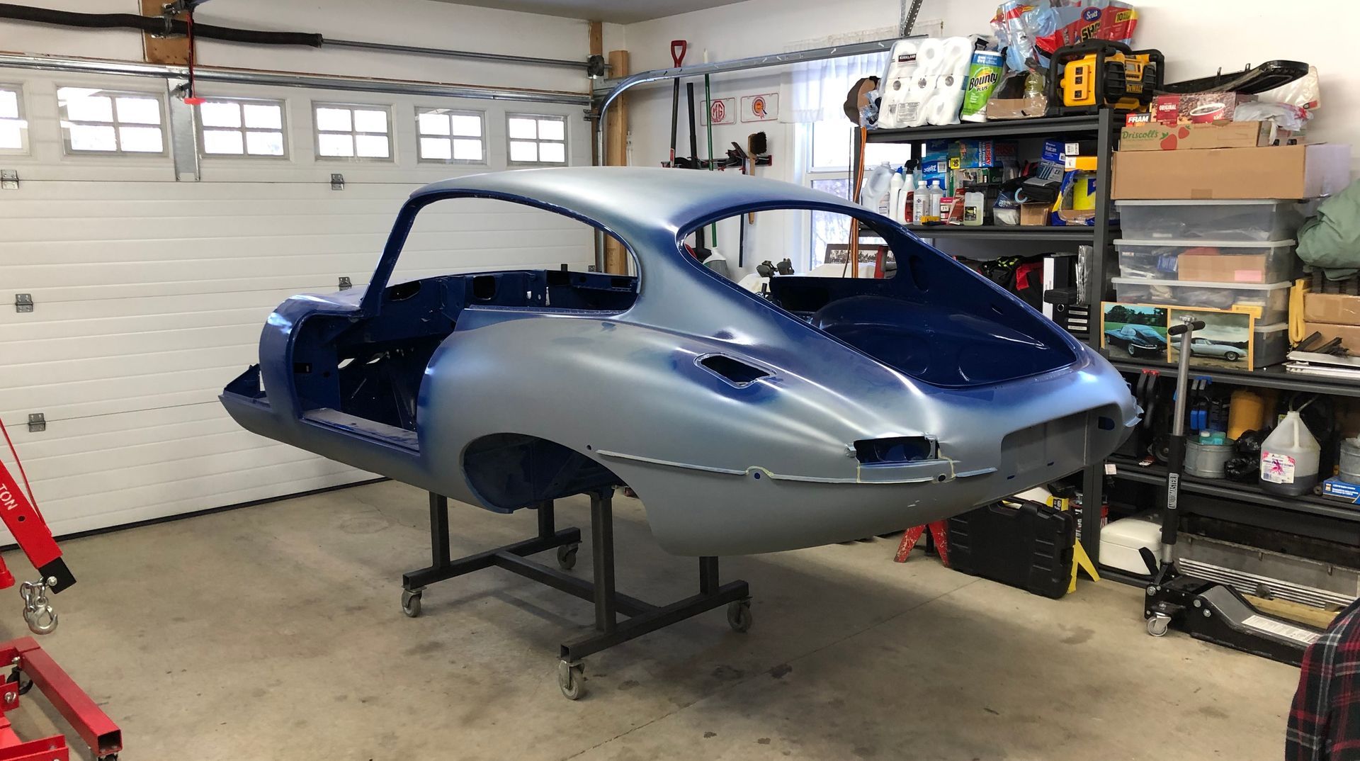 A car is sitting on a stand in a garage.
