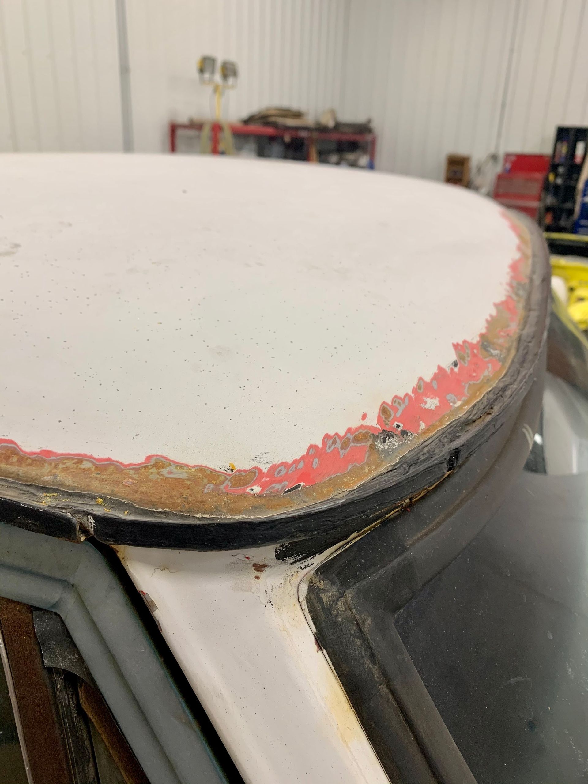 A close up of the roof of a car in a garage.