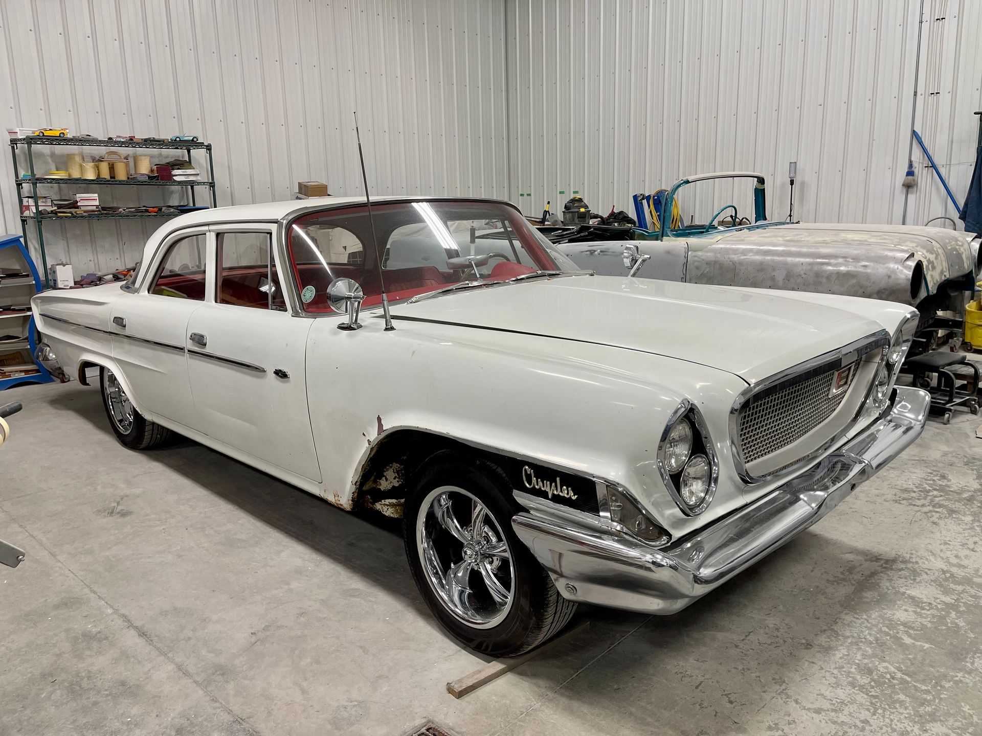 A white car is parked in a garage.