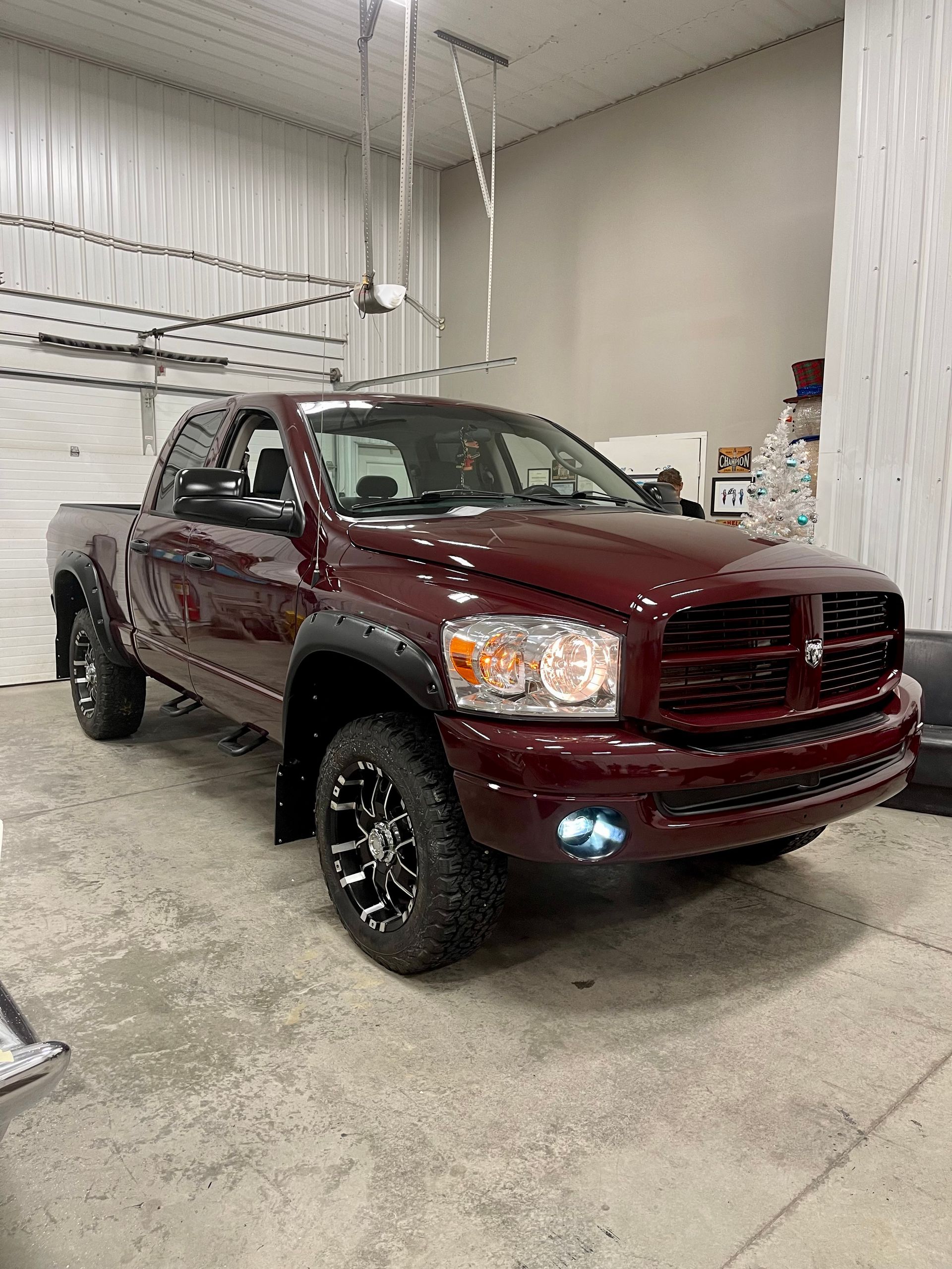 A red dodge ram truck is parked in a garage.