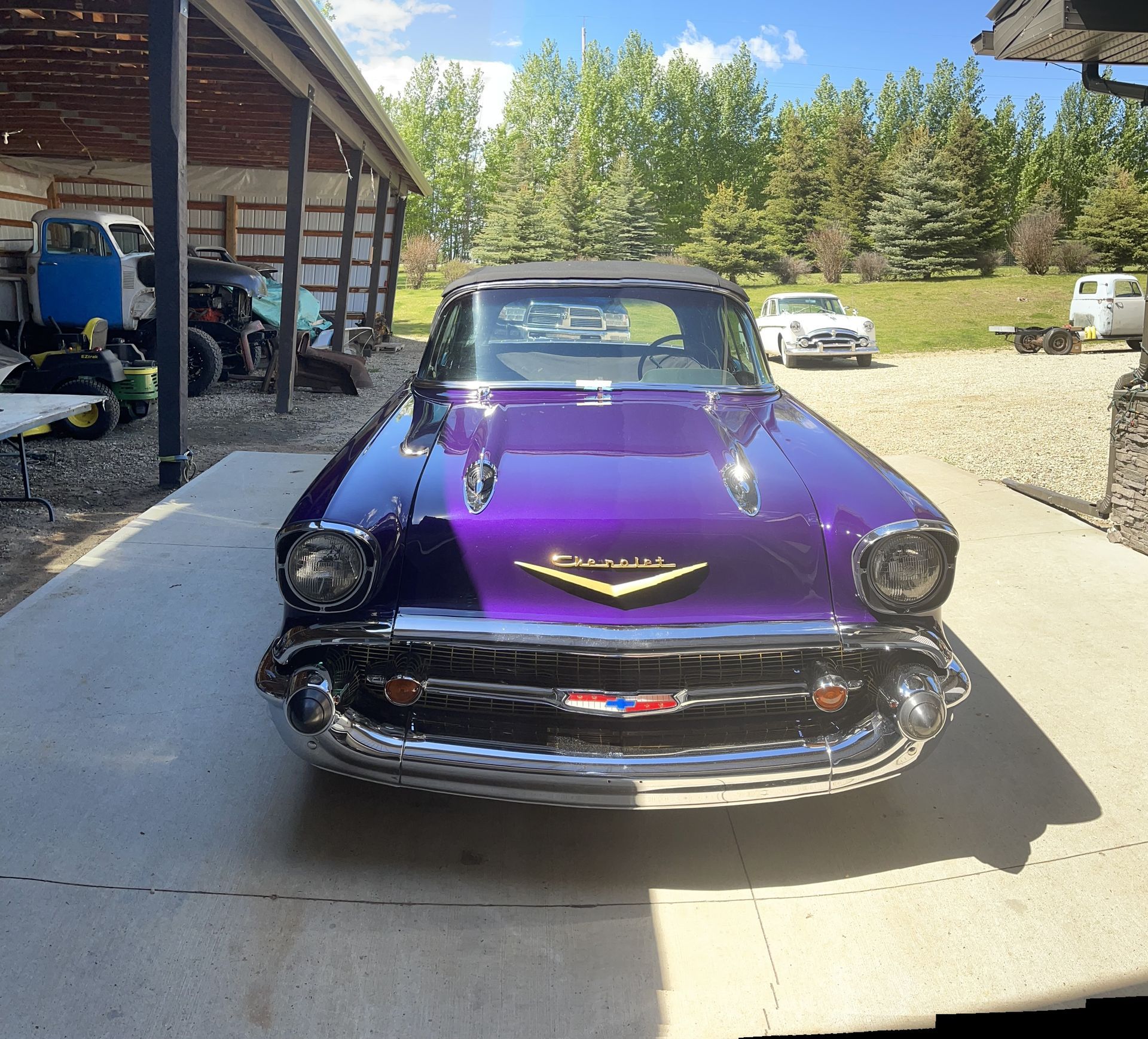 A purple car is parked in a parking lot
