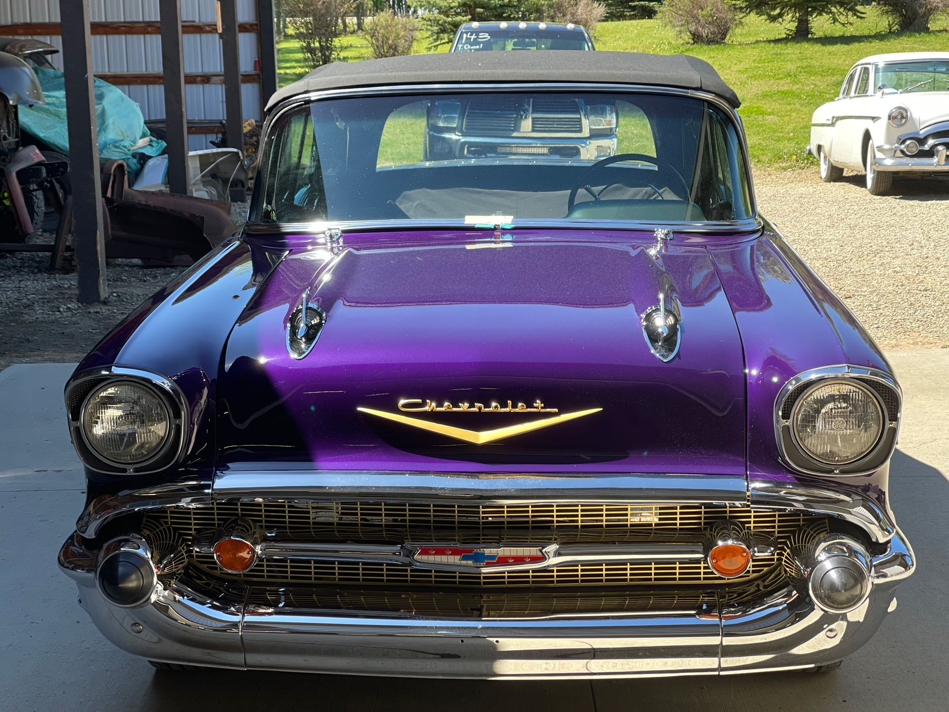 A purple chevrolet is parked in a driveway