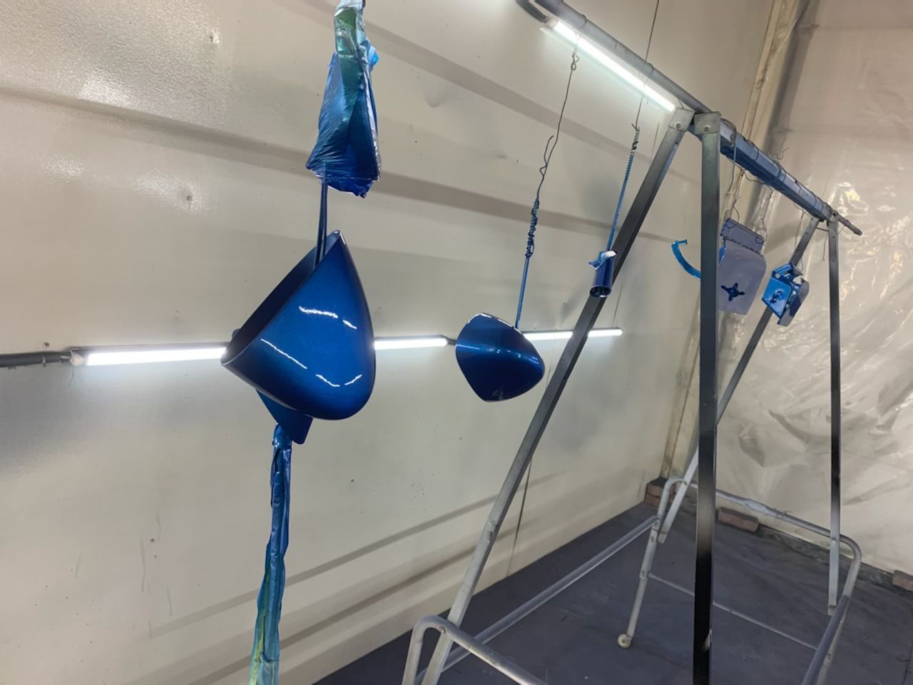 A bunch of blue objects are hanging on a rack