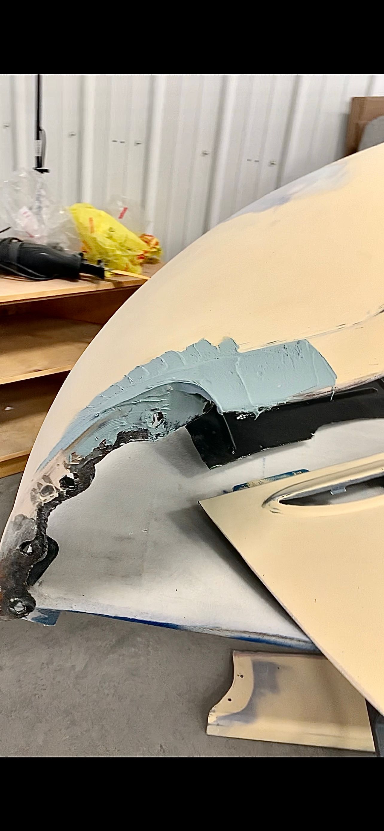 A piece of foam is sitting on top of a piece of wood.