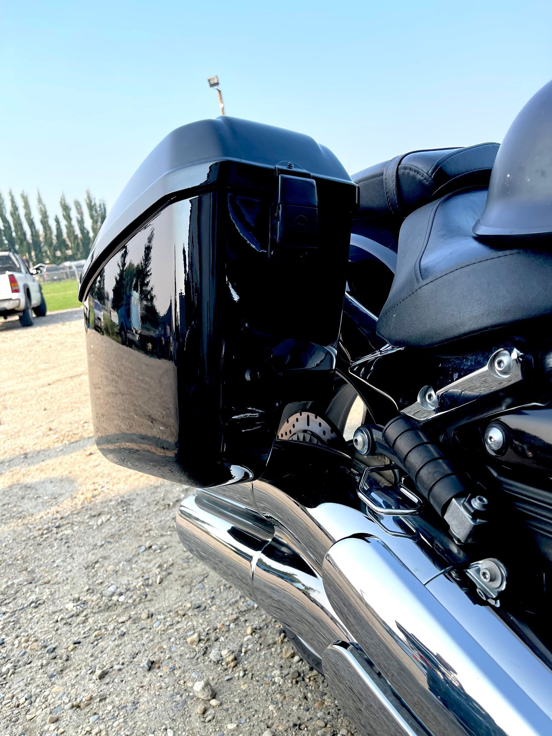 A black motorcycle is parked on a gravel road
