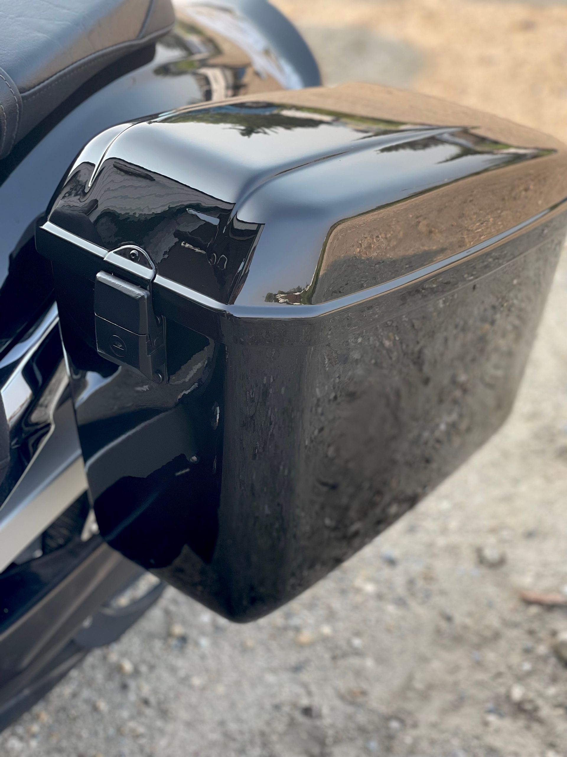 A black motorcycle is parked on the side of the road.