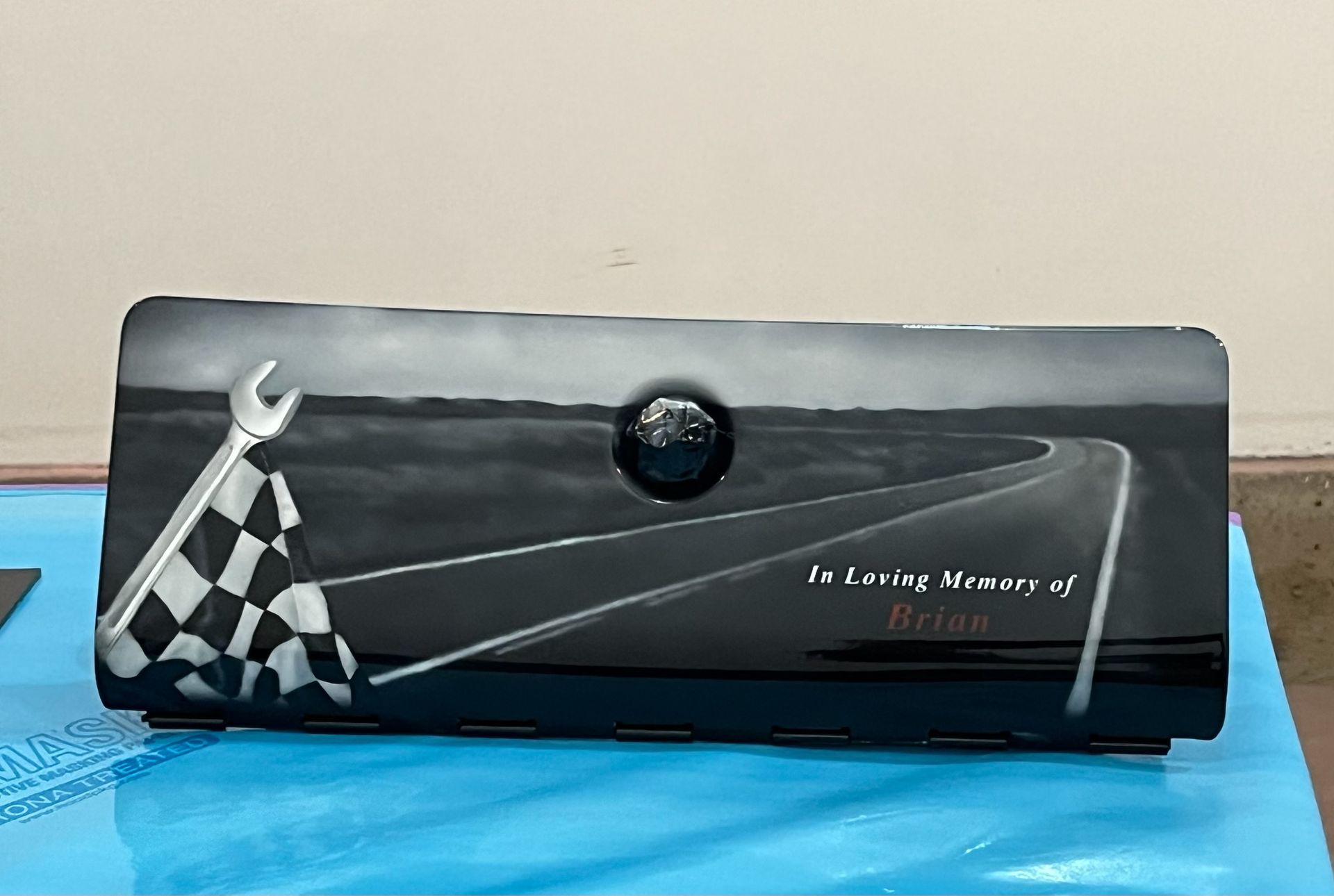 A black box with a checkered flag and a wrench on it