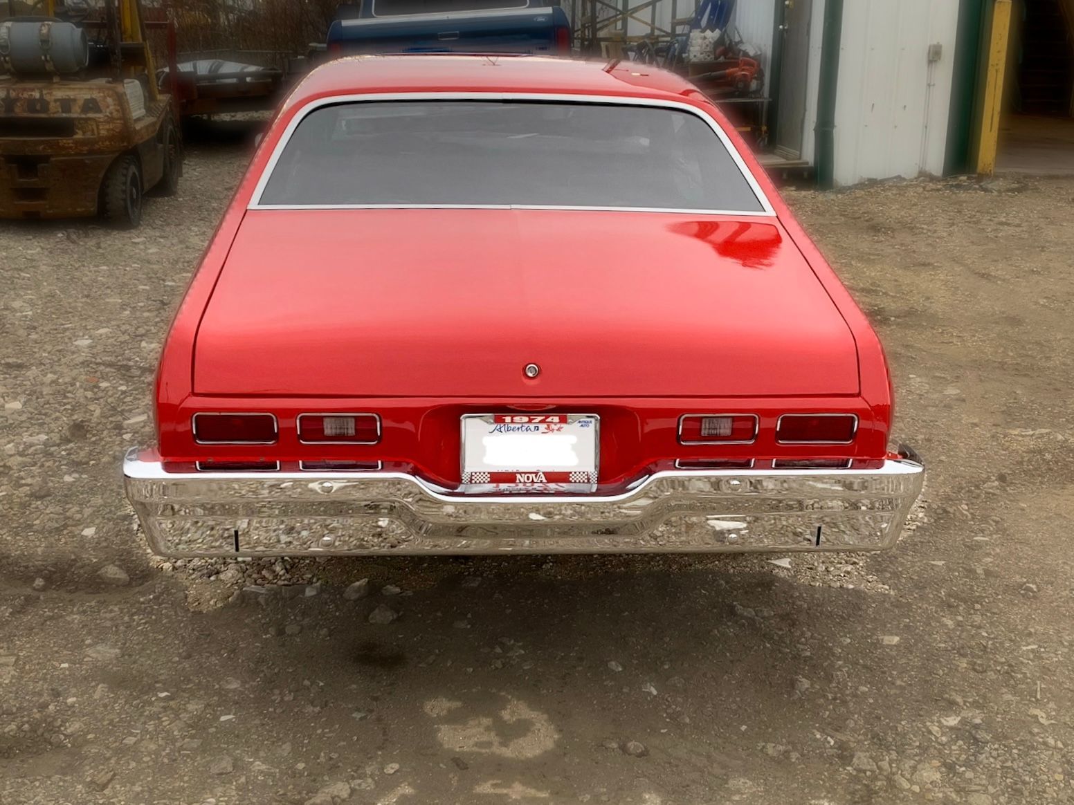 A red car with a california license plate