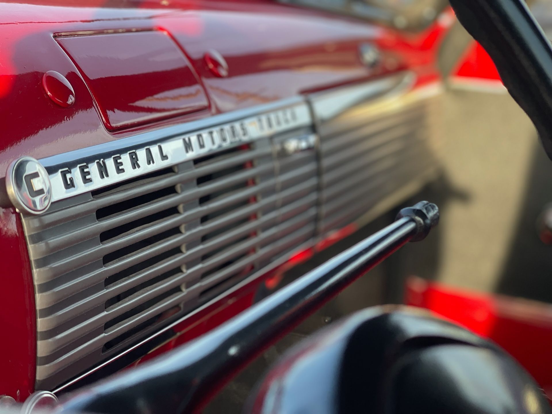 The front of a red general motors truck