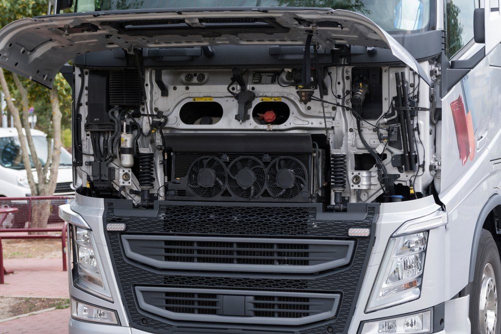 The hood of a truck is open and the engine is visible — Fletcher's Truck and 4WD Repair Centre in Forster, NSW