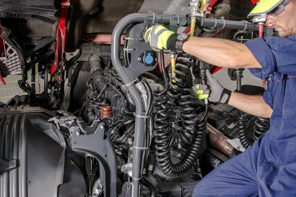 Two Men Are Working on The Engine of A Truck — Fletcher's Truck and 4WD Repair Centre in Tuncurry, NSW