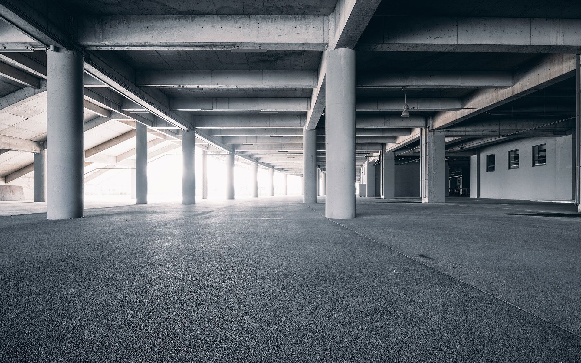 A black and white photo of an empty parking garage.