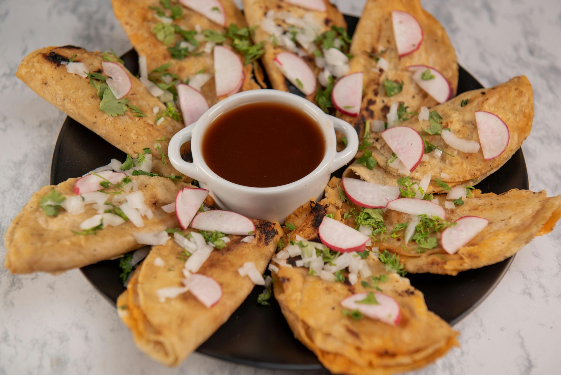 A plate of food with a dipping sauce on the side