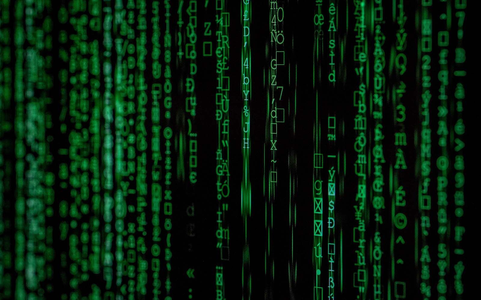 Green digital rain against a black background, resembling code.