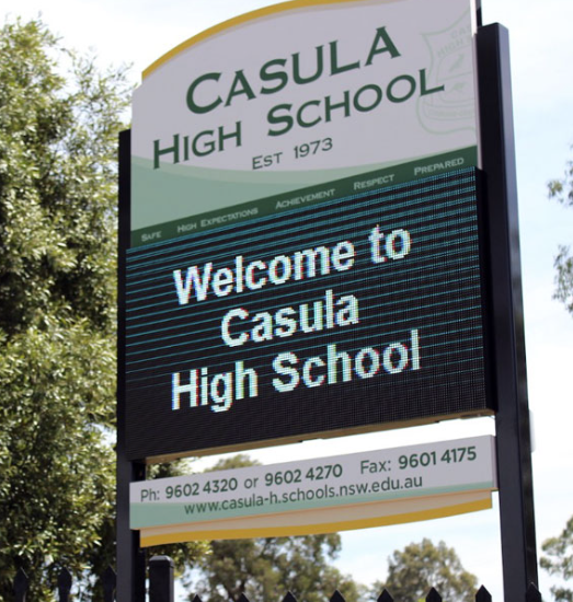 Sign for Casula High School with school name, welcome message, and contact info.