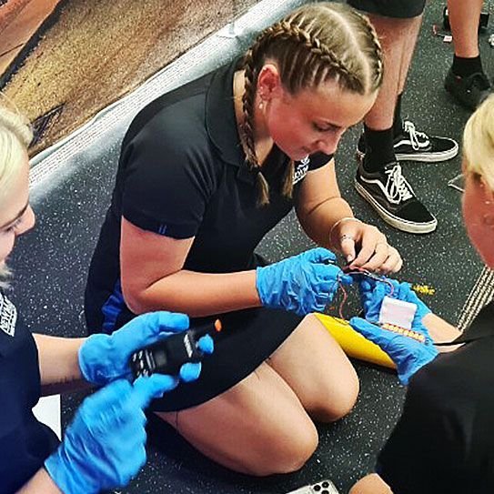 students gathering evidence in Crime Story's crime scene workshop