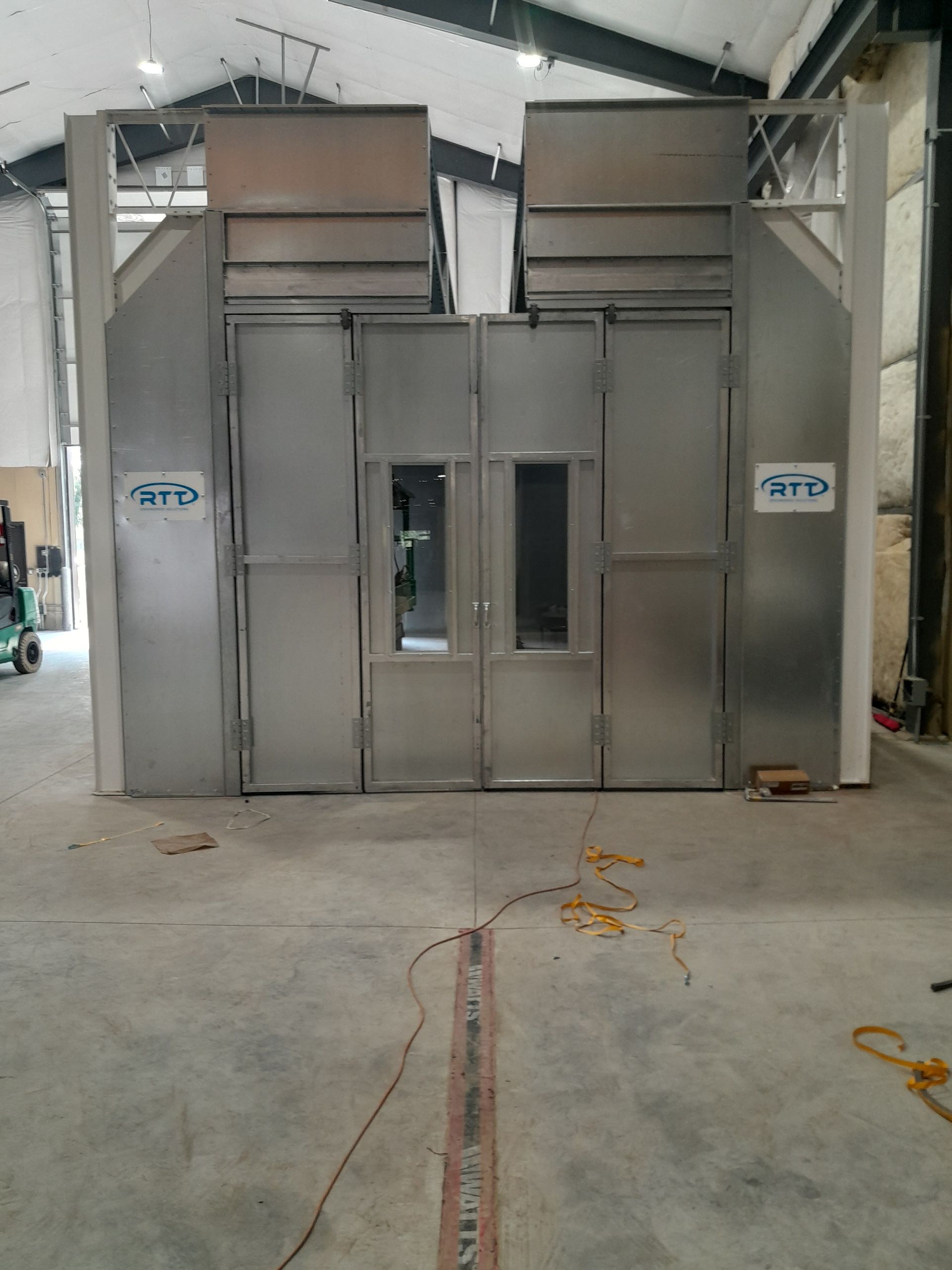 A large stainless steel building with a lot of doors and windows.