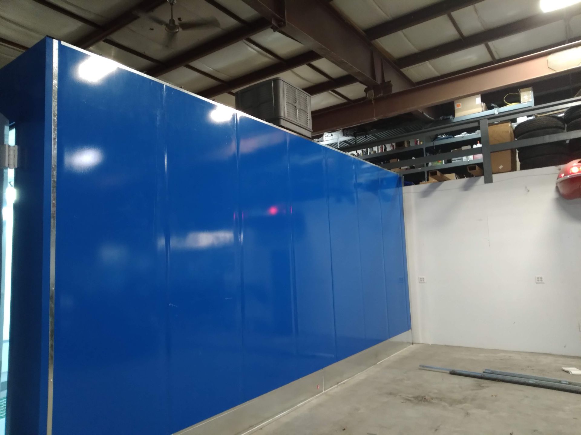 A large blue wall is in the middle of a building.