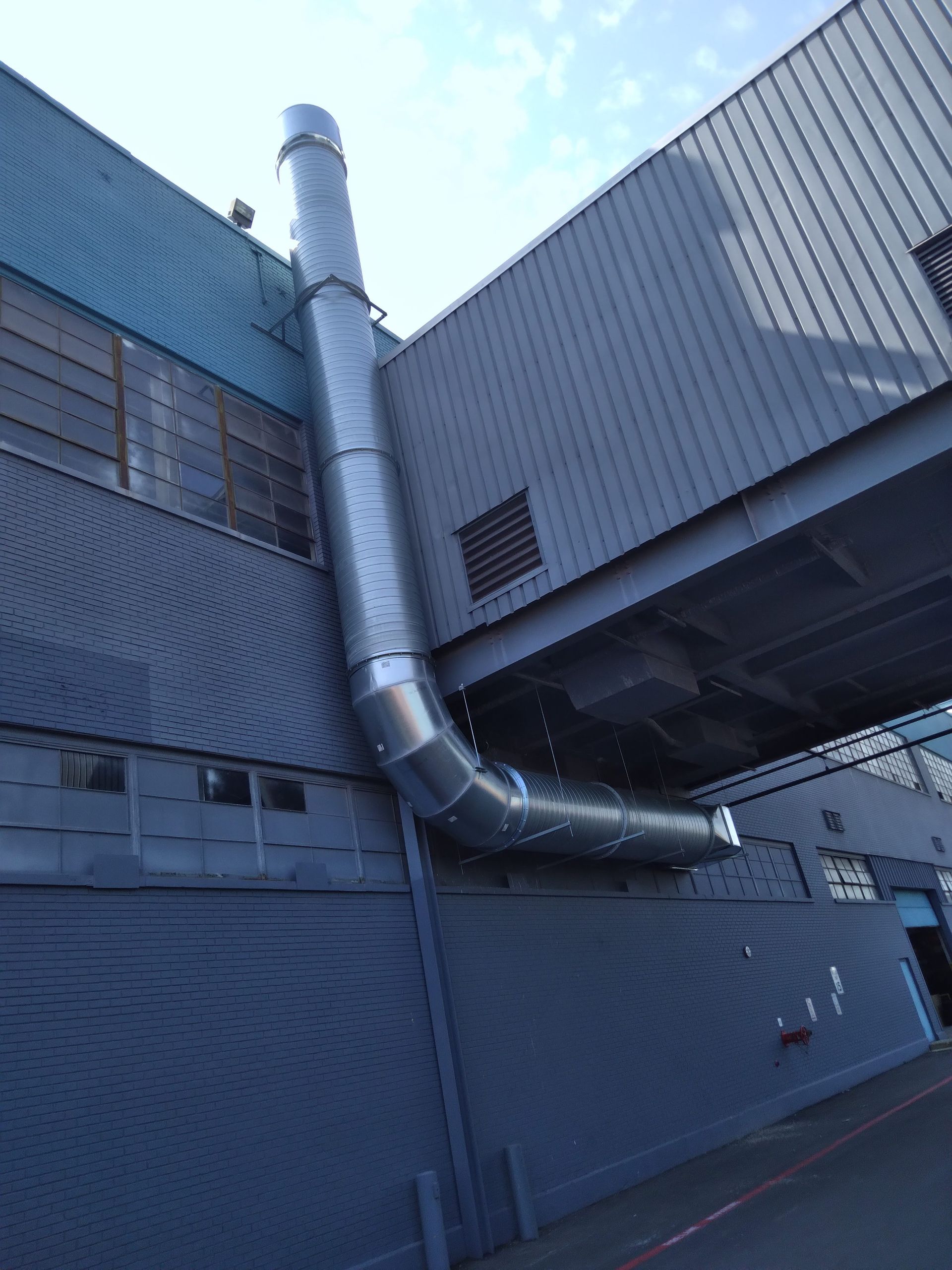 A large pipe is attached to the side of a building