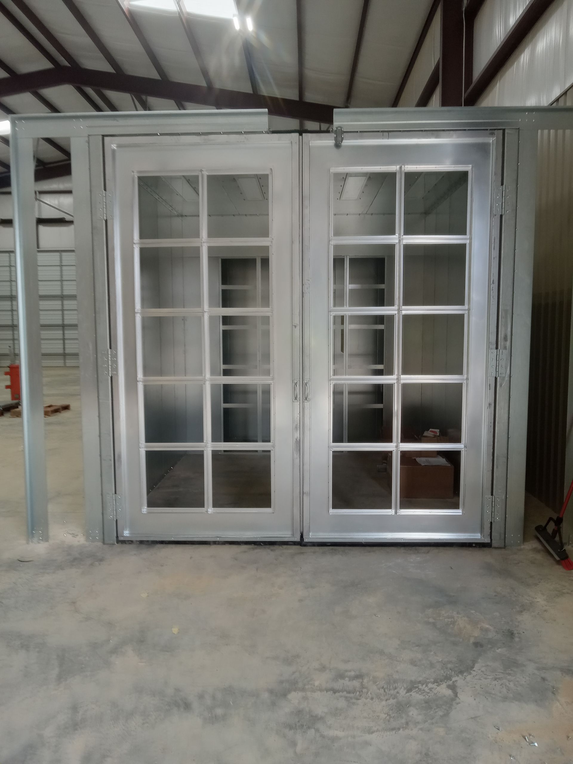 A metal building with a lot of windows and doors