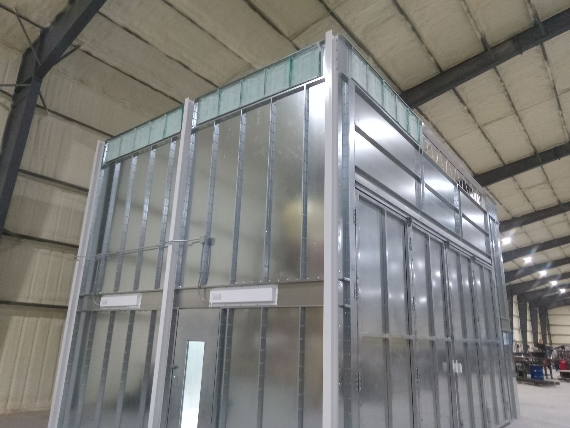 A large metal building with a lot of windows in a building.