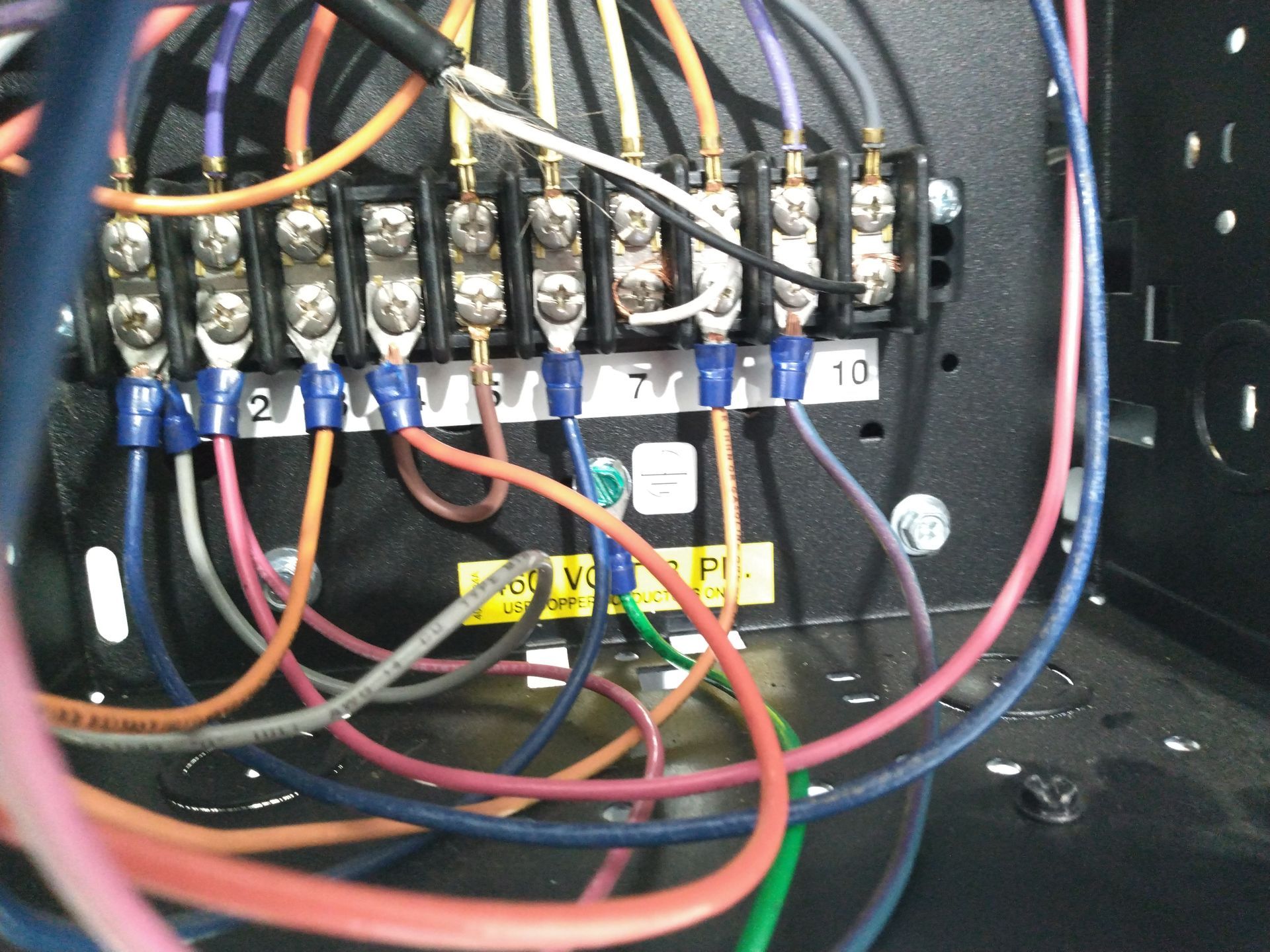 A bunch of wires are connected to a terminal block