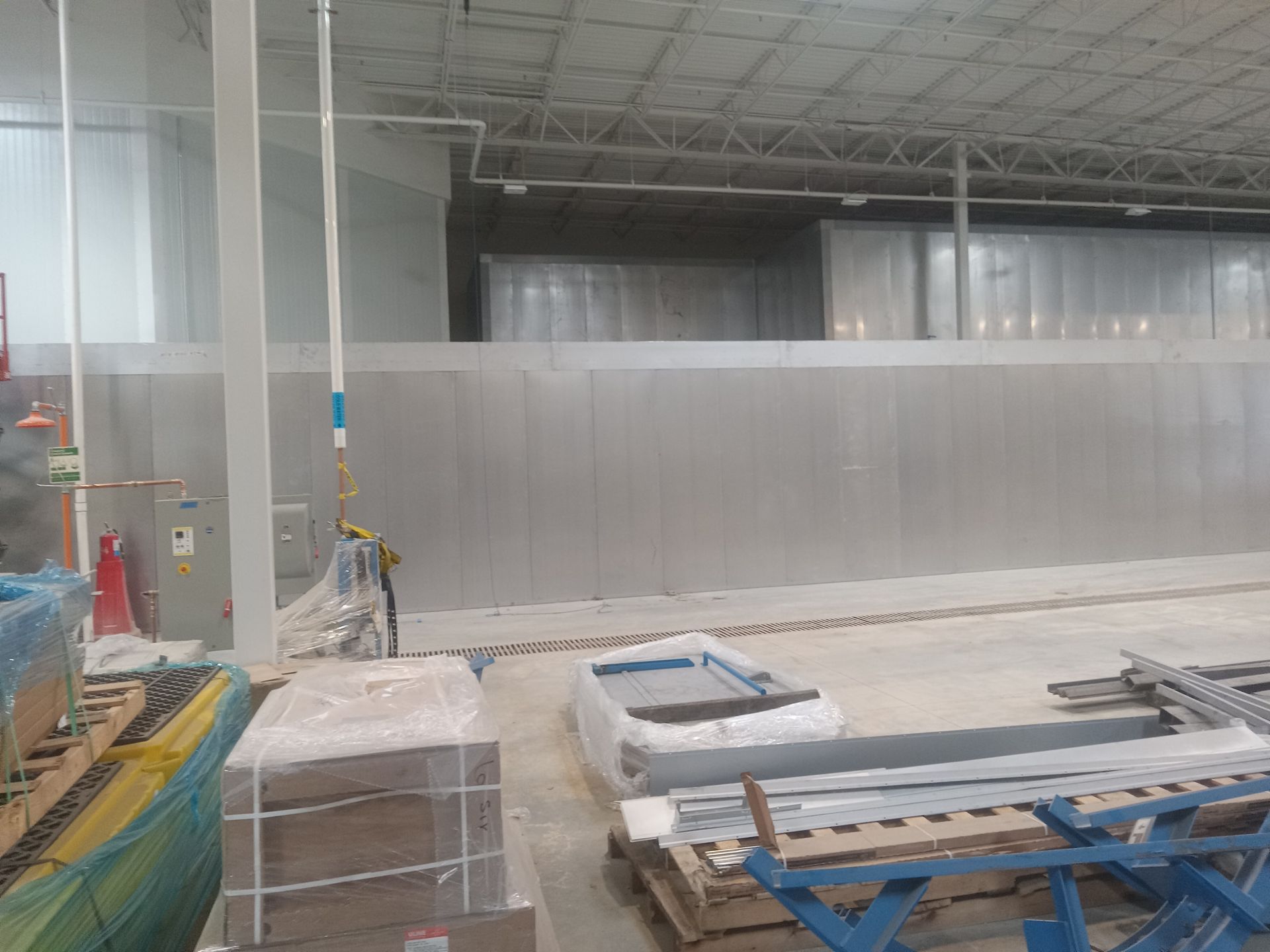A large warehouse with a lot of boxes on the floor.