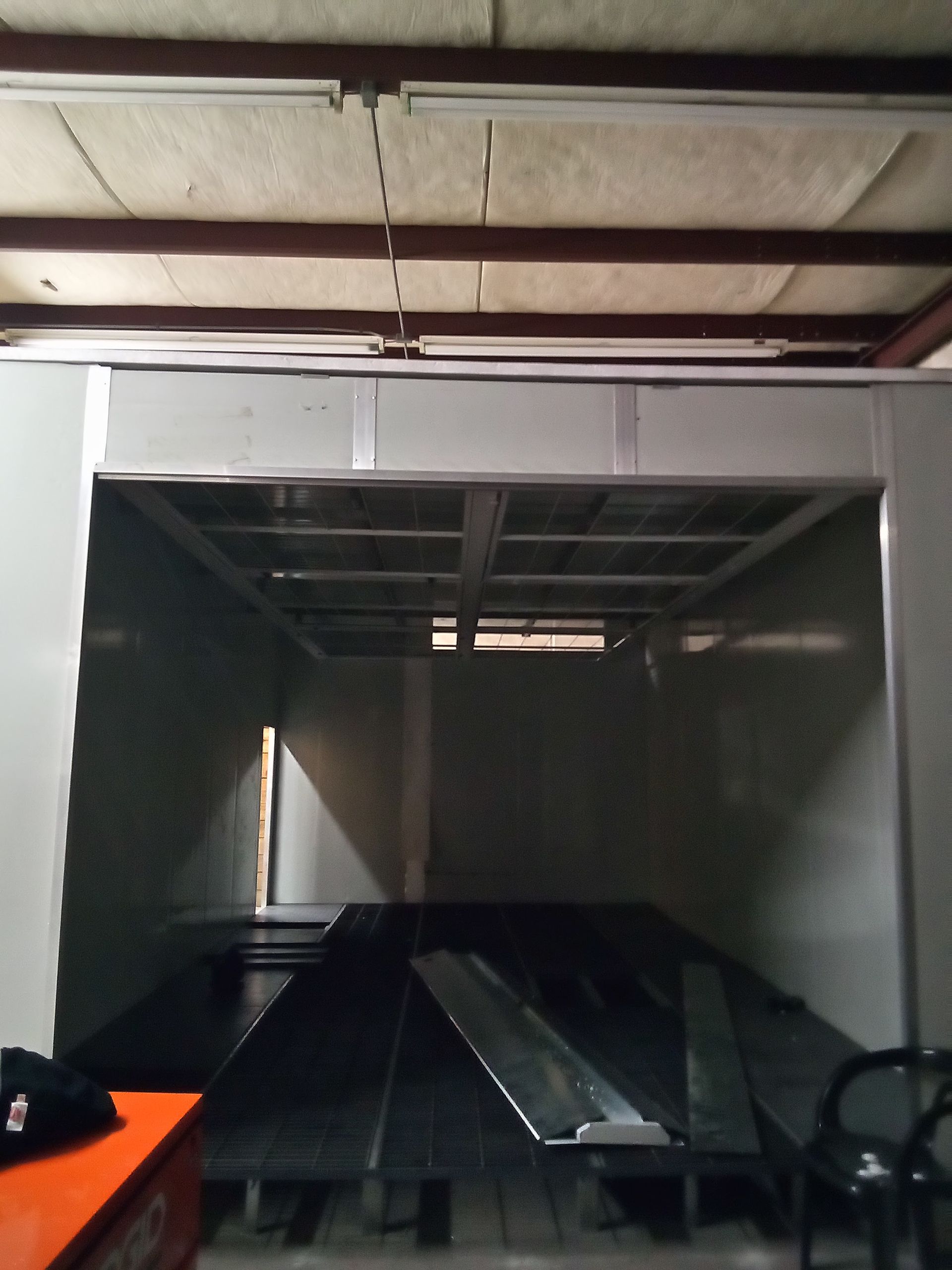 A dark room with a table and chairs in it